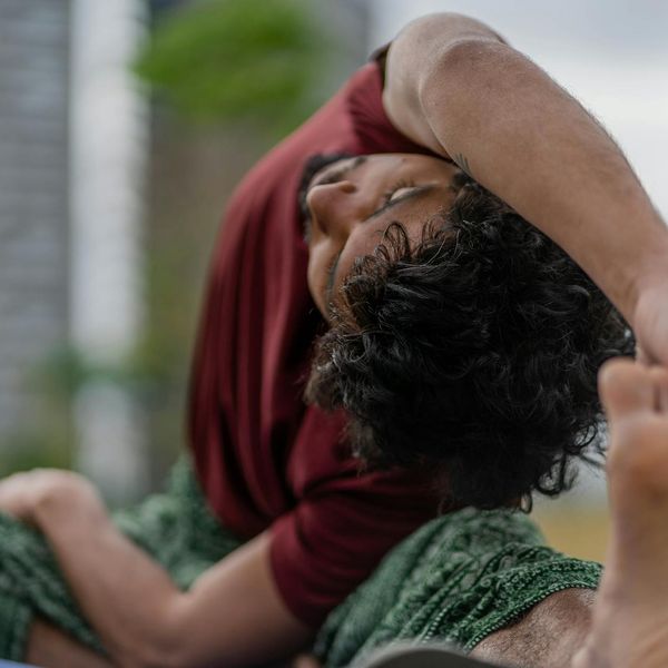 Person demonstrating a deep stretching yoga pose, showing enhanced flexibility.